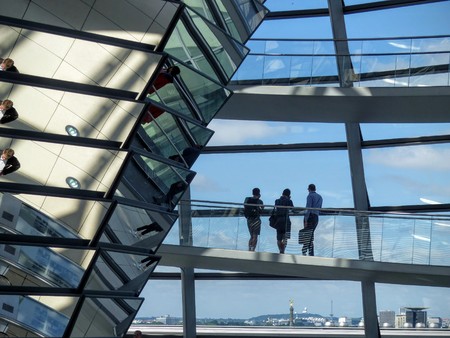 Interior of the glass dome of the Berlin Reichtag with three standing men watching the landscape. Germanyのeditorial素材