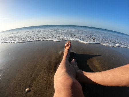 Female feet on the sand of the beach. Vacation concept.の写真素材