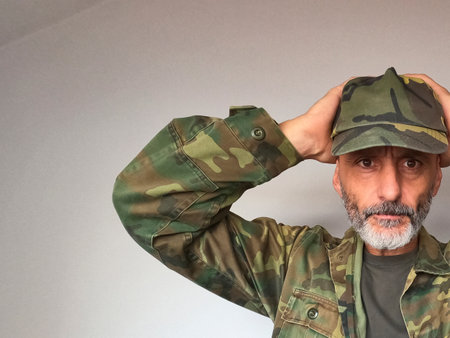 Portrait of a mature soldier in a military uniform saluting.の写真素材