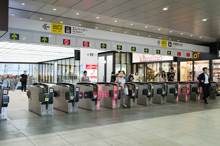 TOKYO, JAPAN-CIRCA JULY, 2014:People passing the gate. Commutor trains are the main mode of...