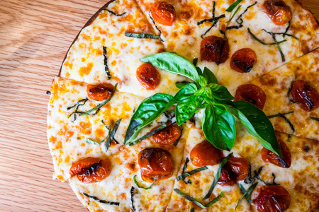 Traditional Italian pizza on wooden boardの写真素材