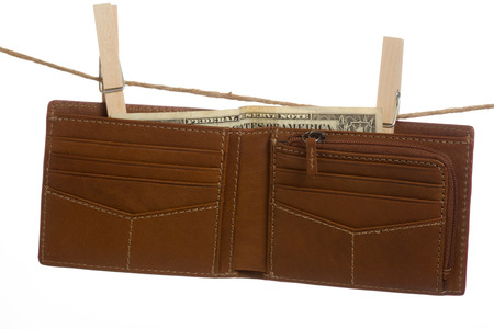Brown leather wallet with dollar bill inside