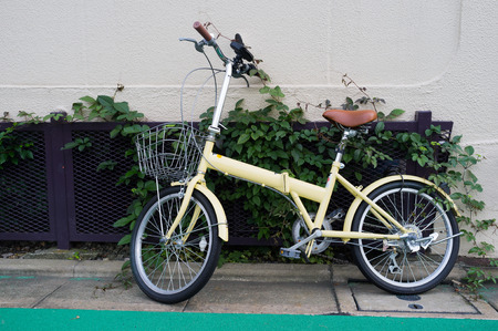 Parked yellow folding bicycle in Tokyo, Japanの写真素材