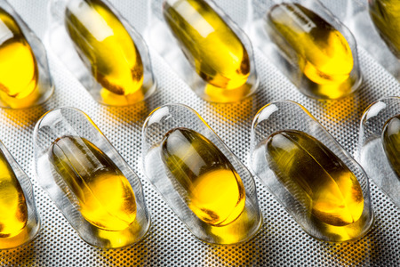 Golden oil viltamin pill - close upの写真素材