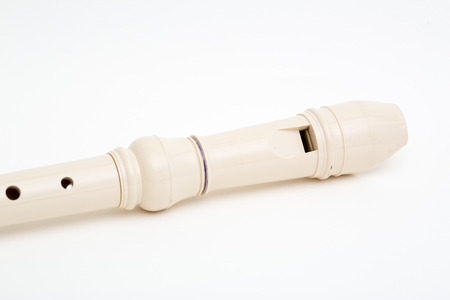 A kid's plastic flute on white backgroundの写真素材