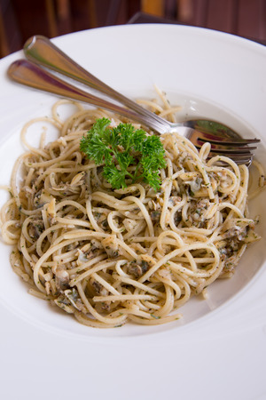 Delicious venus clam spaghetti with basil and garlicの写真素材