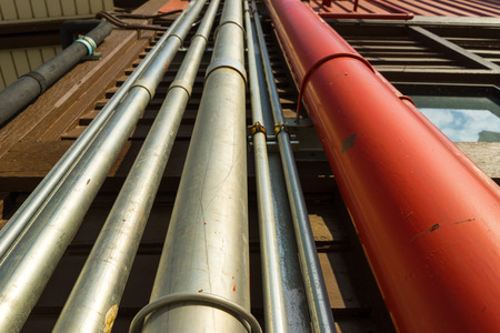 Outdoor metal piping in silver and red color