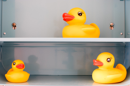 Toy yellow duck with blue back groundの写真素材