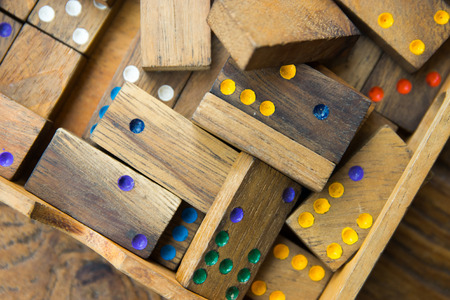 Domino play pieces lying on a wooden table