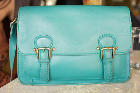 pastel blue hand bag on a tableの写真素材