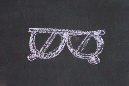 Chalk cartoon drawn on black black boardの写真素材