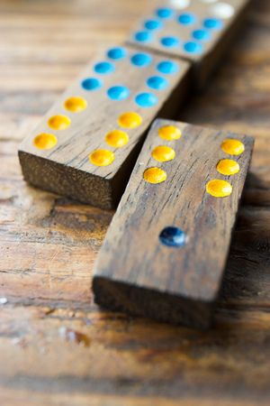 Domino play pieces lying on a wooden tableの写真素材