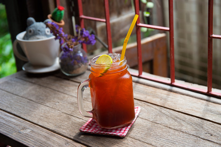 Iced lemon lime tea on vitage table in a jugの写真素材