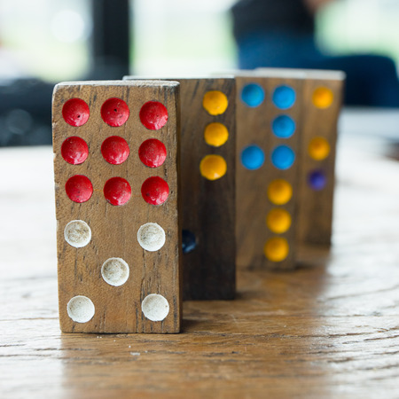 Domino play pieces lying on a wooden tableの写真素材