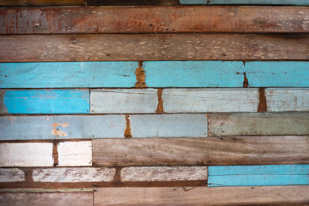Colored grungy wooden surface with peeled paint