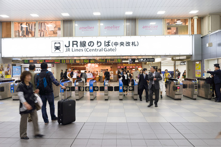 OSAKA, JAPAN CIRCA APRIL 2016:People passes the gate. Commuter trains are the main mode of transportation in Tokyo.のeditorial素材