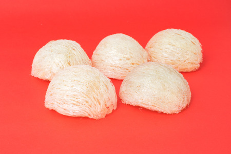 Fresh edible bird's nest on red paper