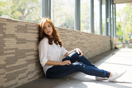 Young attractive asian female relaxing in casual clothingの写真素材