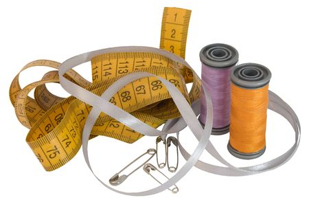 sartorial metre, two spools, silk tape and five stickpins on white backgroundの写真素材