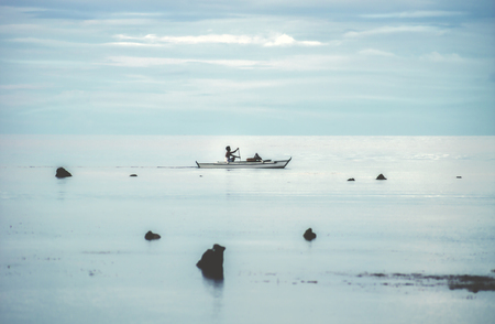 Fisher in the endless turquoise sea at iiquijor island, Philippinesの写真素材