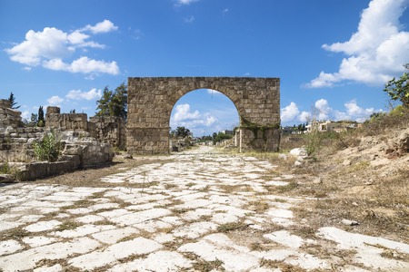 Byzantine road with triumph arch with blue sky and clouds in ruins of Tyre, Lebanonの写真素材