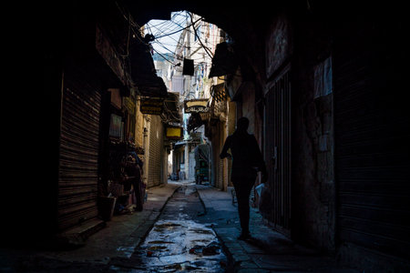 Tripoli, Lebanon - October 9 2015: Tripoli, Lebanon - October 9 2015: Women walking in the dark streets of the souks of Tripoli at friday afternoon, when many shops are closedのeditorial素材