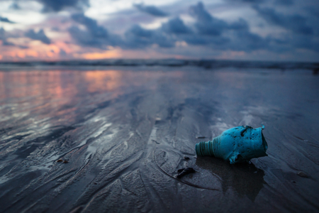 Plastic bottle, garbish and trash littering the ocean at the beach during sunset, Koh Lanta, Thailandの写真素材