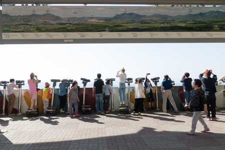 Dora Observatory, DMZ, South Korea - September 8 2017: Tourists watching with binoculars to North Korean village Propaganda village or Peace village at Korean Demilitarized Zone, map of North Korean villageのeditorial素材
