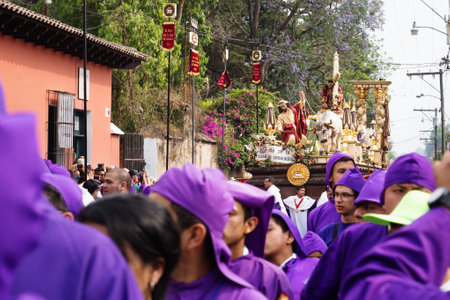 Antigua, Guatemala: March 18 2018: Altar boy in front of a float with Christ and a cross at the procession of San Bartolome de Becerra in 1a Avenidaのeditorial素材