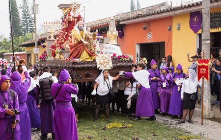 Antigua, Guatemala: March 18 2018: Woman in front of a float with Mary, John and Jesus on top at the procession of San Bartolome de Becerra in 1a Avenidaのeditorial素材