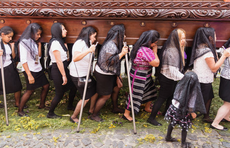 Antigua, Guatemala: March 18 2018: Women with black veils carrying a float at the procession of San Bartolome de Becerra in 1a Avenidaのeditorial素材