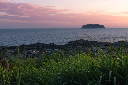 Dramatic colours with pink and orange during sunset with view to Beomseom at Seaseom, Seogwipo, Jeju...