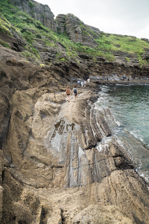 Yongmeori Beach, Sanbang-ro, Jeju Island, South Korea - August 28 2017: Tourists walking along the cliffsのeditorial素材