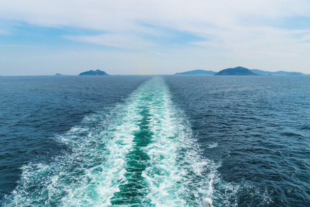 Boat trail waves in the ocean from the ferry from the way from Jeju Island to Mokpo with small islandsの写真素材