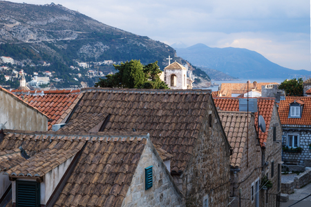 View over the old city Dubrovnik with ancient roofs and mountains and dramatic cloudscape, Croatiaの写真素材