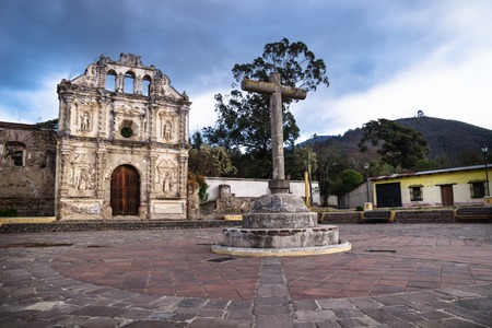 Church fassade ruin of Ermita de Santa Isabel and mountain with dramatic blue cloudscape, Antigua, Guatemalaの素材 [FY310118919864]