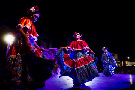 Merida, Mexico - October 27 2018: Dancing Catrinas with skull make up for dias de los muertos with traditional dresses at Remate de Paseo Montejo at Festival de las Animasのeditorial素材