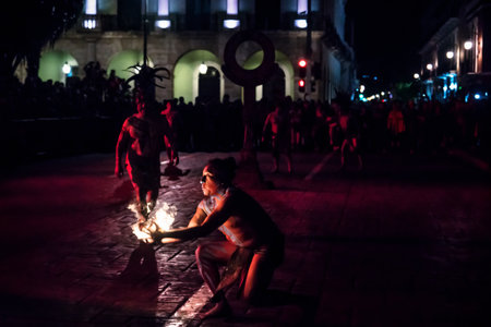 Merida, Mexico - 26 January 2019: Pok ta Pok traditional Mayan ball game performance, man catching ball in fire at Plaza Grandeのeditorial素材