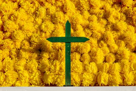 Mexican yellow flower altar with green cross for day of the dead, dia de muertos, Merida, Mexico