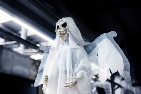 Skeleton ghost puppet as decoration for halloween, day of the dead with industrial background in...