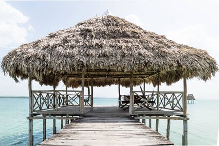 Lake dock with relaxing hammocks at a sunny day, El Remate, Guatemalaの写真素材