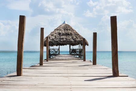 Lake dock with hammocks at a sunny day, El Remate, Guatemalaの写真素材