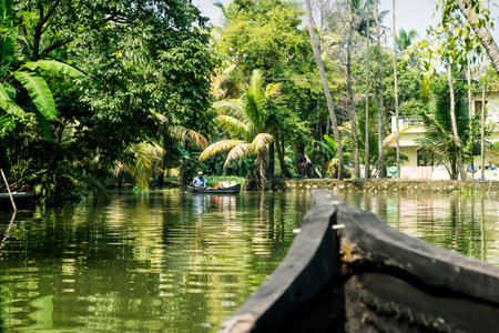 Alleppey - Alappuzha, India - 13 November 2017: Boat tour through the small canals of the Kerala backwaters along small boat drivers and houses,のeditorial素材