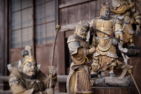 Fierce looking Fudo statues at the entrance of a Daishoin shrine, Miyashima, Japanのeditorial素材