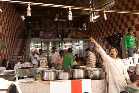 Ajmer, Rajasthan, India - 12 March 2012: Man screaming in front of local kitchen of Indian food stall at the marketのeditorial素材