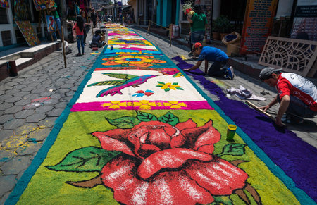 Santiago Atitlan, Guatemala - 30 March 2018: Local people making hummingbird alfombra, colorful sawdust carpets for Semana Santa, Easter on the streetのeditorial素材