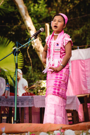 Bilu Kyun, Ogre Island, Mon State, Myanmar - 12 January 2013: Girl in traditional burmese dress singing on stage on a new year celebrationのeditorial素材