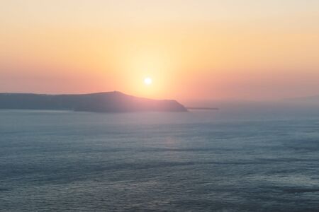 Blurred purple orange sunset abstract background along the coast of Fira, Santorini, Greeceの写真素材