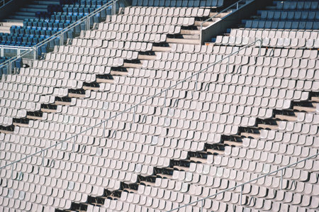 Empty sunlit chairs on the tribune of the Stadium in Barcelona, Spain