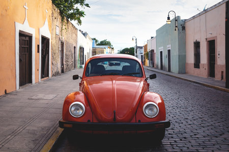 Merica, Yucatan, Mexico - 28 October 2018 - Front of red Oldtimer Volkswagen Beetle in the colonial historical streets at 'Casa Culcal Kin'のeditorial素材